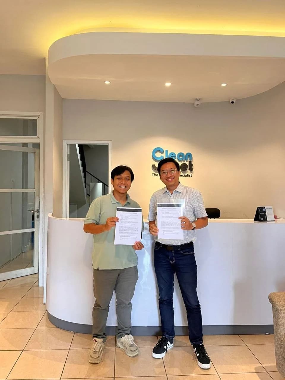 Kalayudha Impact and CleanSheet representatives holding the signed partnership agreement